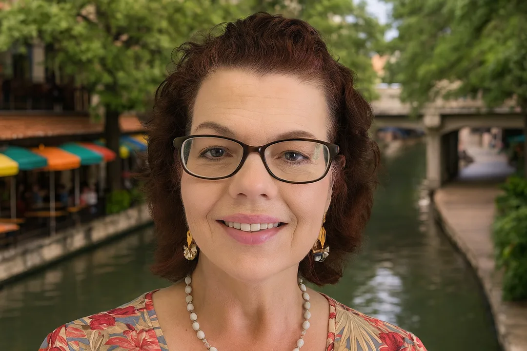 Pattie Porter wearing glasses with San Antonio River Walk behind her